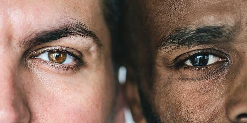 two-different-ethnic-men-39-s-eyes-closeup-P68AUHD